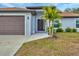 Front entrance of a house, featuring a brown door and palm trees at 328 San Marino Ave, North Port, FL 34287