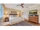 Bright bedroom with a queen-size bed, wood floors, and a large TV at 3318 Bayou Sound, Longboat Key, FL 34228