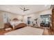 Main bedroom with king-size bed, access to patio, and hardwood floors at 3318 Bayou Sound, Longboat Key, FL 34228