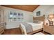 Charming bedroom with wood floors and plantation shutters at 3318 Bayou Sound, Longboat Key, FL 34228