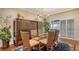Bright dining room with glass-top table, wicker chairs, and access to a patio at 3318 Bayou Sound, Longboat Key, FL 34228