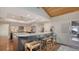 Open kitchen with granite counters, breakfast bar, and access to backyard at 3318 Bayou Sound, Longboat Key, FL 34228