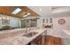 Granite countertops, stainless steel sink, and wood ceiling add to this kitchen's charm at 3318 Bayou Sound, Longboat Key, FL 34228