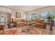 Bright living room with hardwood floors, comfortable seating, and large windows at 3318 Bayou Sound, Longboat Key, FL 34228