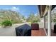 Brick patio with grill and potted plants, offering a relaxing outdoor space at 3318 Bayou Sound, Longboat Key, FL 34228
