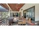 Relaxing screened patio with wicker furniture and a fire pit at 3318 Bayou Sound, Longboat Key, FL 34228