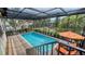 Enclosed pool and patio area with steps and lounge chairs at 3318 Bayou Sound, Longboat Key, FL 34228