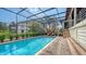 Inviting pool area with screened enclosure, lounge chairs, and brick pavers at 3318 Bayou Sound, Longboat Key, FL 34228