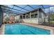Inviting screened pool area with plenty of lounge chairs at 3318 Bayou Sound, Longboat Key, FL 34228