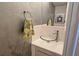 Modern powder room with glass vessel sink and textured walls at 3333 Ramblewood Ct, Sarasota, FL 34237