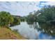 Peaceful canal with tranquil reflections of the sky at 3333 Ramblewood Ct, Sarasota, FL 34237