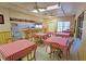 Well-equipped community kitchen featuring a breakfast bar and tables at 3333 Ramblewood Ct, Sarasota, FL 34237