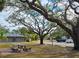 Relaxing courtyard with picnic tables under large oak trees at 3333 Ramblewood Ct, Sarasota, FL 34237