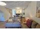 Open concept living area with kitchen, hardwood floors, and a sofa at 3333 Ramblewood Ct, Sarasota, FL 34237