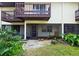 Ground level patio with screen enclosure and lush landscaping at 3333 Ramblewood Ct, Sarasota, FL 34237