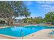 Refreshing community pool with lounge chairs and patio tables at 3333 Ramblewood Ct, Sarasota, FL 34237