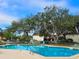 Community pool with ample lounge chairs for sunbathing at 3333 Ramblewood Ct, Sarasota, FL 34237