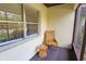 Relaxing screened porch with wicker chair and side table at 3333 Ramblewood Ct, Sarasota, FL 34237