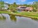 Waterfront property showcasing a single-story home with pool and lush landscaping at 3726 Beneva Oaks Blvd, Sarasota, FL 34238