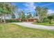 Landscaped grounds and a spacious driveway leading to a single-story home at 3726 Beneva Oaks Blvd, Sarasota, FL 34238