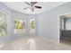 Bright bedroom with tile floors, window blinds, and a ceiling fan at 408 Golden Harbour Trl, Bradenton, FL 34212