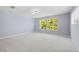 Large bedroom with neutral walls and carpet flooring and two windows at 408 Golden Harbour Trl, Bradenton, FL 34212