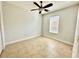 Bright bedroom with tile floors and a ceiling fan at 408 Golden Harbour Trl, Bradenton, FL 34212