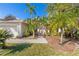Landscaped front yard with palm trees and a brick walkway leading to the house at 408 Golden Harbour Trl, Bradenton, FL 34212