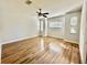 Main bedroom with hardwood floors, large windows, and a ceiling fan at 408 Golden Harbour Trl, Bradenton, FL 34212
