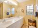 Double vanity bathroom with updated fixtures and a large mirror at 4216 Central Sarasota Pkwy # 1326, Sarasota, FL 34238