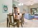 Bright dining area with table and chairs, open to living room at 4216 Central Sarasota Pkwy # 1326, Sarasota, FL 34238