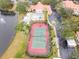 Community tennis court with red surface and green playing area at 4216 Central Sarasota Pkwy # 1326, Sarasota, FL 34238