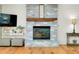 Living room fireplace with whitewashed brick and a rustic wooden mantel at 4520 Robin Hood W Trl, Sarasota, FL 34232