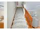 Gray carpeted staircase with wooden railing at 4520 Robin Hood W Trl, Sarasota, FL 34232