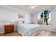 Bedroom with a queen-size bed, light walls, and a window overlooking water at 4570 Pinebrook Cir # 303, Bradenton, FL 34209