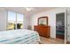 Bedroom with large windows, wood-like floors, and built-in dresser at 4570 Pinebrook Cir # 303, Bradenton, FL 34209