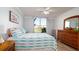 Spacious bedroom with water views, hardwood floors, and ceiling fan at 4570 Pinebrook Cir # 303, Bradenton, FL 34209