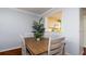 Dining area with wood table and white chairs at 4570 Pinebrook Cir # 303, Bradenton, FL 34209