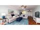 Spacious living room with comfy sofas, a large TV and wood floors at 4570 Pinebrook Cir # 303, Bradenton, FL 34209