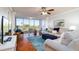Living room with comfy sofas, a large TV, and wood floors at 4570 Pinebrook Cir # 303, Bradenton, FL 34209