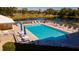 Relaxing pool area with plenty of lounge chairs and umbrellas at 4570 Pinebrook Cir # 303, Bradenton, FL 34209