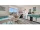Bright bedroom featuring a comfortable recliner, workspace, and a soothing blue and white decor at 4802 51St W St # 1118, Bradenton, FL 34210
