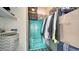 Functional closet with shelving, hanging space, and a turquoise dresser for organized storage at 4802 51St W St # 1118, Bradenton, FL 34210