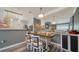 Cozy dining area with stylish chairs, a rustic table, and a mirror, next to the kitchen at 4802 51St W St # 1118, Bradenton, FL 34210