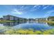 Scenic view of condo buildings overlooking a serene pond and landscaped grounds at 4802 51St W St # 1118, Bradenton, FL 34210