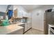 An updated kitchen with modern appliances, tiled backsplash, white cabinets and light countertops at 4802 51St W St # 1118, Bradenton, FL 34210