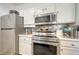 Close-up of kitchen area with stainless steel appliances and white cabinetry at 4802 51St W St # 1118, Bradenton, FL 34210