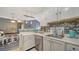 Stylish kitchen with white cabinetry, modern appliances, and an adjacent dining area at 4802 51St W St # 1118, Bradenton, FL 34210