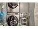 Convenient laundry area with stacked washer and dryer units with custom heart and leaf design at 4802 51St W St # 1118, Bradenton, FL 34210