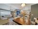 Open-concept living and dining area with modern furniture, lighting fixtures and finishes at 4802 51St W St # 1118, Bradenton, FL 34210